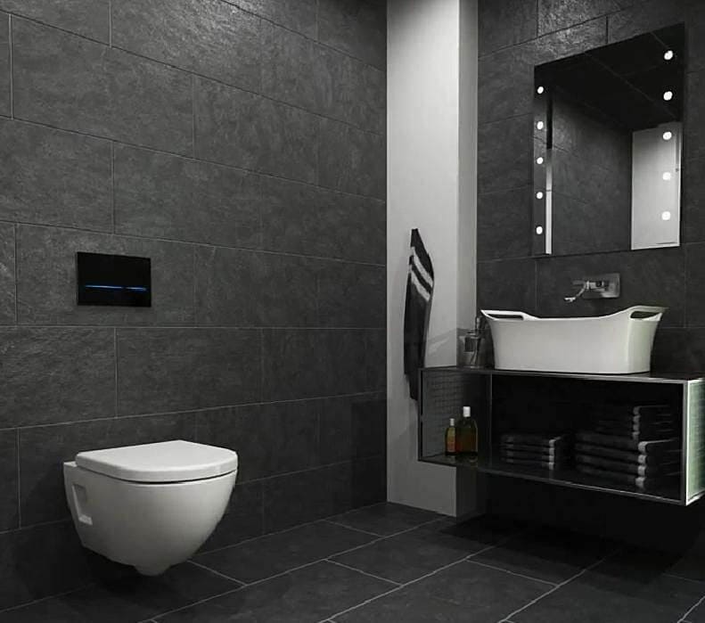 Geberit black modern flush plate in a dark bathroom, Geberit wall hung toilet, countertop basin, mirror with lights