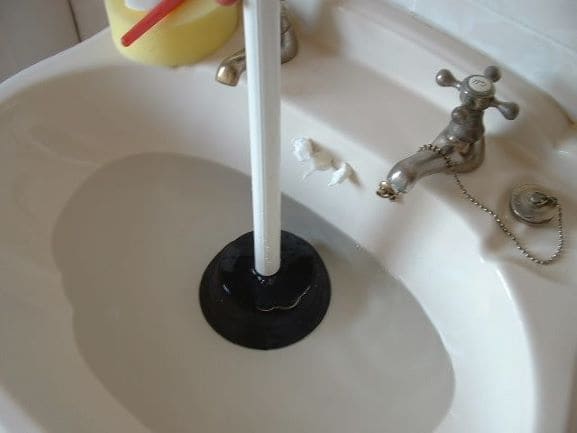 plunger used in a sink full of water