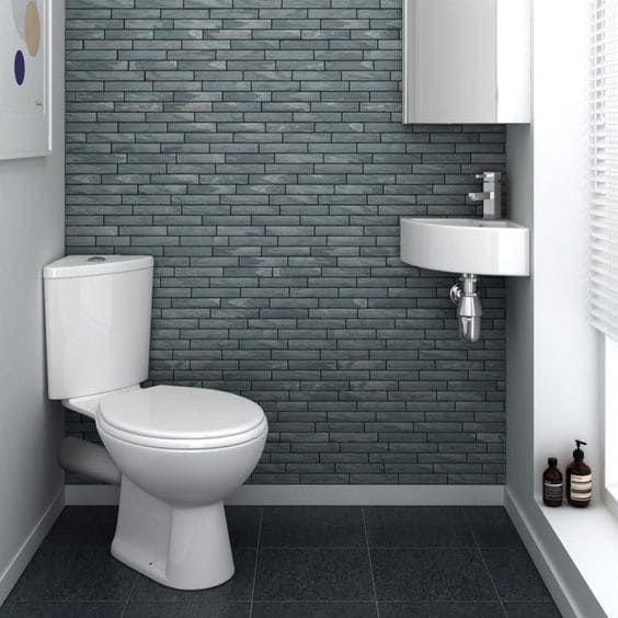 small bathroom with white corner toilet and sink