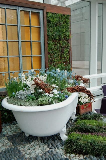 Bathtub with flowers inside in a garden