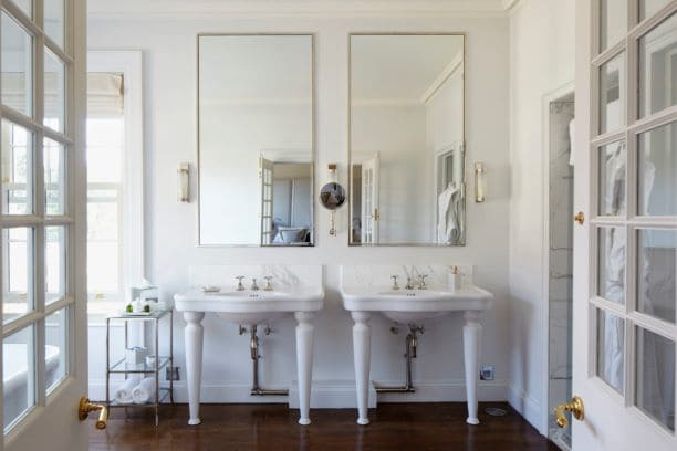 Luxurious traditional but modern hotel bathroom with two sinks pedestal sinks