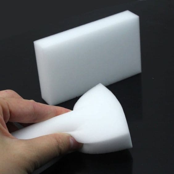 magic cleaner sponge being squeezed for cleaning a shower glass