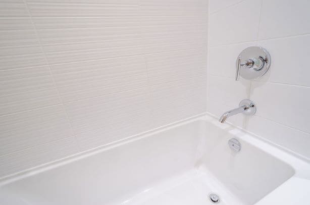 white bathtub with concealed bathroom tap